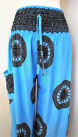 Broek Mandala dua blauw.  Met breed elastiek in taille/ heupband, sierkoordje aan voorzijde, opgestikt zijvakje en elastiek in enkels. Wijde pijp en normaal kruis. Binnenbeenlengte 79 cm. Heupwijdte tot 1.15 m, taille tot max 84 cm. 100% rayon.