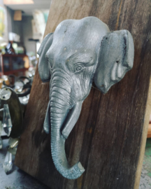 Old tin elephant on wooden plate