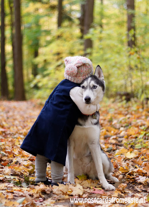 Child embraces dog