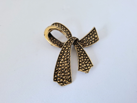 Vintage strikbroche, goudkleurig met zwart
