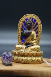 Golden and black Buddha with blue led light