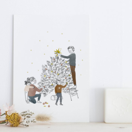 A family join together around the Christmas tree