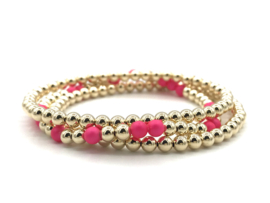 Armband Seline met real gold plated balletjes en neon roze shell