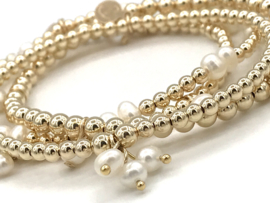 Armband Erva met real gold plated balletjes en bedeltjes van witte pareltjes