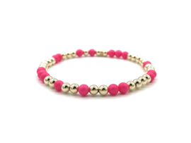 Armband Seline met real gold plated balletjes en neon roze shell