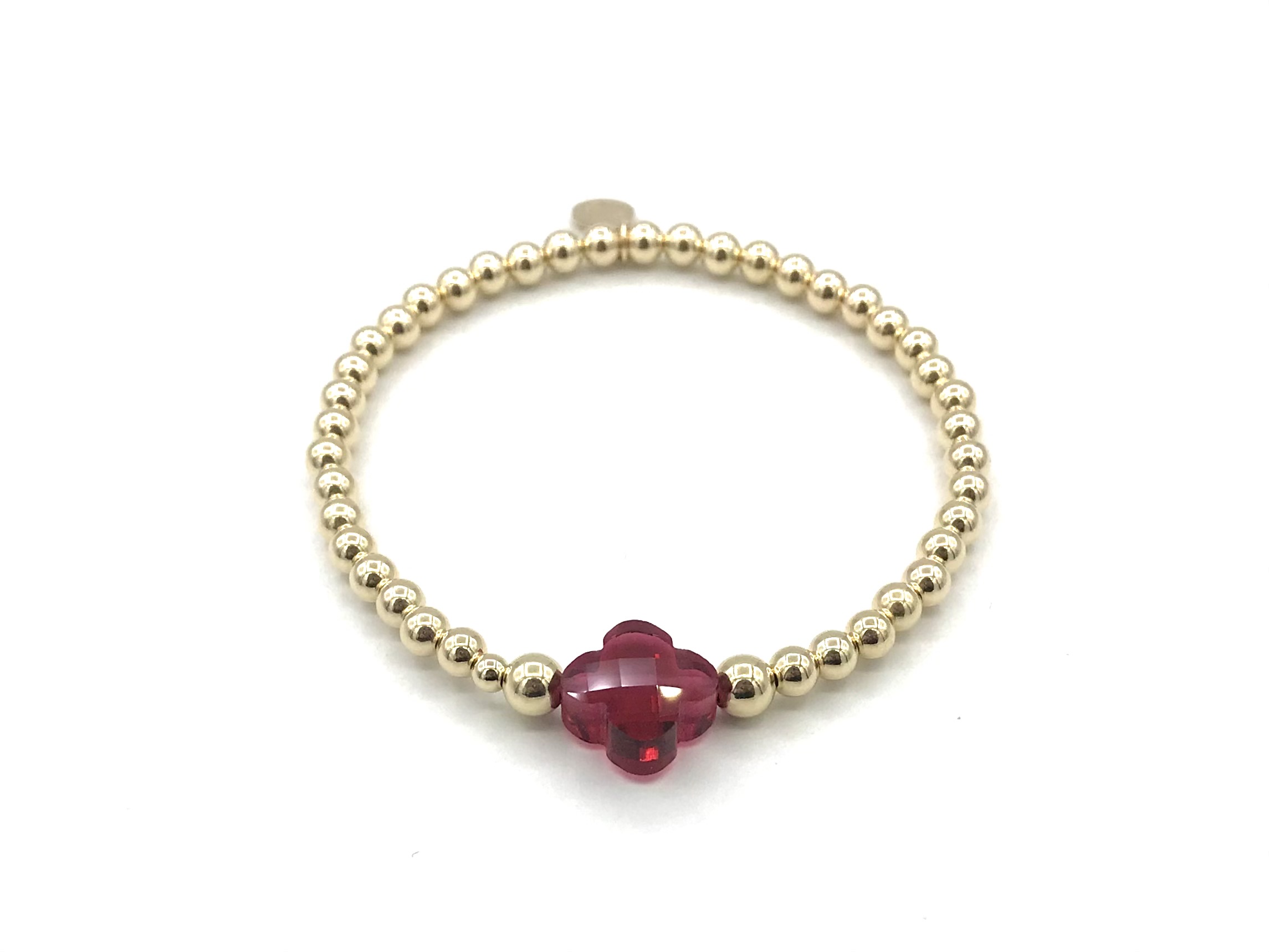Armband Lizzie fuchsia met goudkleurige real gold plated balletjes en roze klavertje