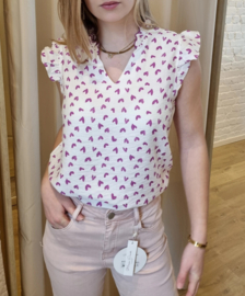 bloesje met volantmouwtjes en frulletjes met hartjesmotief