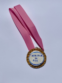 Medaille: Zeester in bed