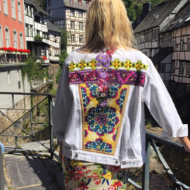 White decorated denim jacket with colored flower patches