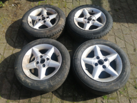 14 inch aluminium velgen met band 175/65R14 Nissan 40300-51C26 B13/ N14/ Y10 Gebruikt. Lichte schade.