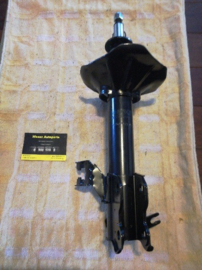 Schokdemper Nissan Almera N15. Linksvoor. 54303-1N525