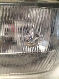 Koplamp links Nissan Bluebird T12 B6060-D4600 (54319328) Gebruikt. Lichte schade.