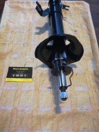 Schokdemper Nissan Almera N15. Linksvoor. 54303-1N525