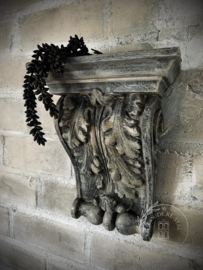 Stenen wandornament/ kandelaar