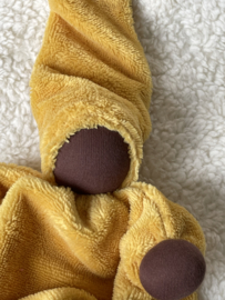 Cuddly doll ocher yellow with dark skin color