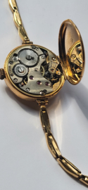 Antiek gouden dameshorloge met verende rekband en kast diameter 2,5 cm