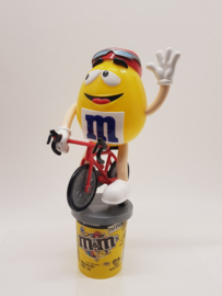 M&M dispencer male on the racing bike