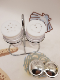 Vintage salt and pepper shakers in holder