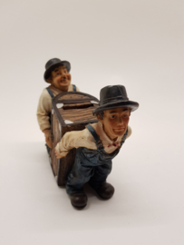 Laurel & Hardy carry the money box piggy bank