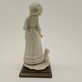 A Belcari statue of a girl with a doll's cart