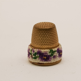 Antique thimble with embroidery rim