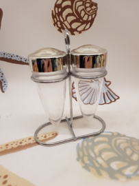 Vintage salt and pepper shakers in holder