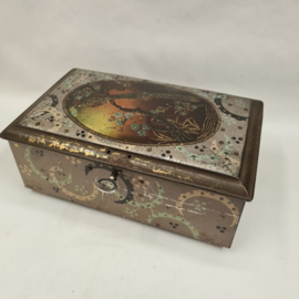 Antique tin with peacock and key