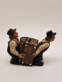 Laurel & Hardy carry the money box piggy bank
