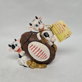Cows on rugby ball money box