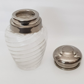 Shaker with silver colored lid
