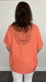 Top met gehaakt detail op de rug koraal