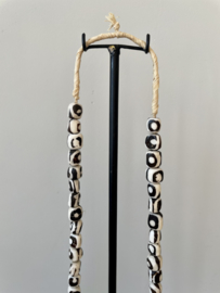 Batik bone beads necklace on metal stand