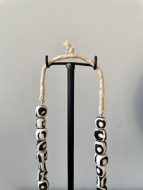 Batik bone beads necklace on metal stand