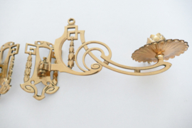 A pair of Art Nouveau brass piano candleholders