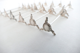 A set of 12 Silver Plated Rococo Knife rests - France, first half of the 20th century