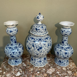 Two Dutch delft baluster vases with floral decor of roses and leaves.