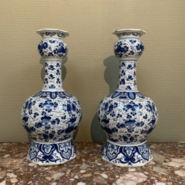 Two Dutch delft baluster vases with floral decor of roses and leaves.