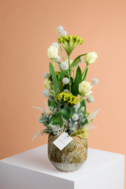 Bloemstuk met tulpen, witte pompons, groene bessen en celosia
