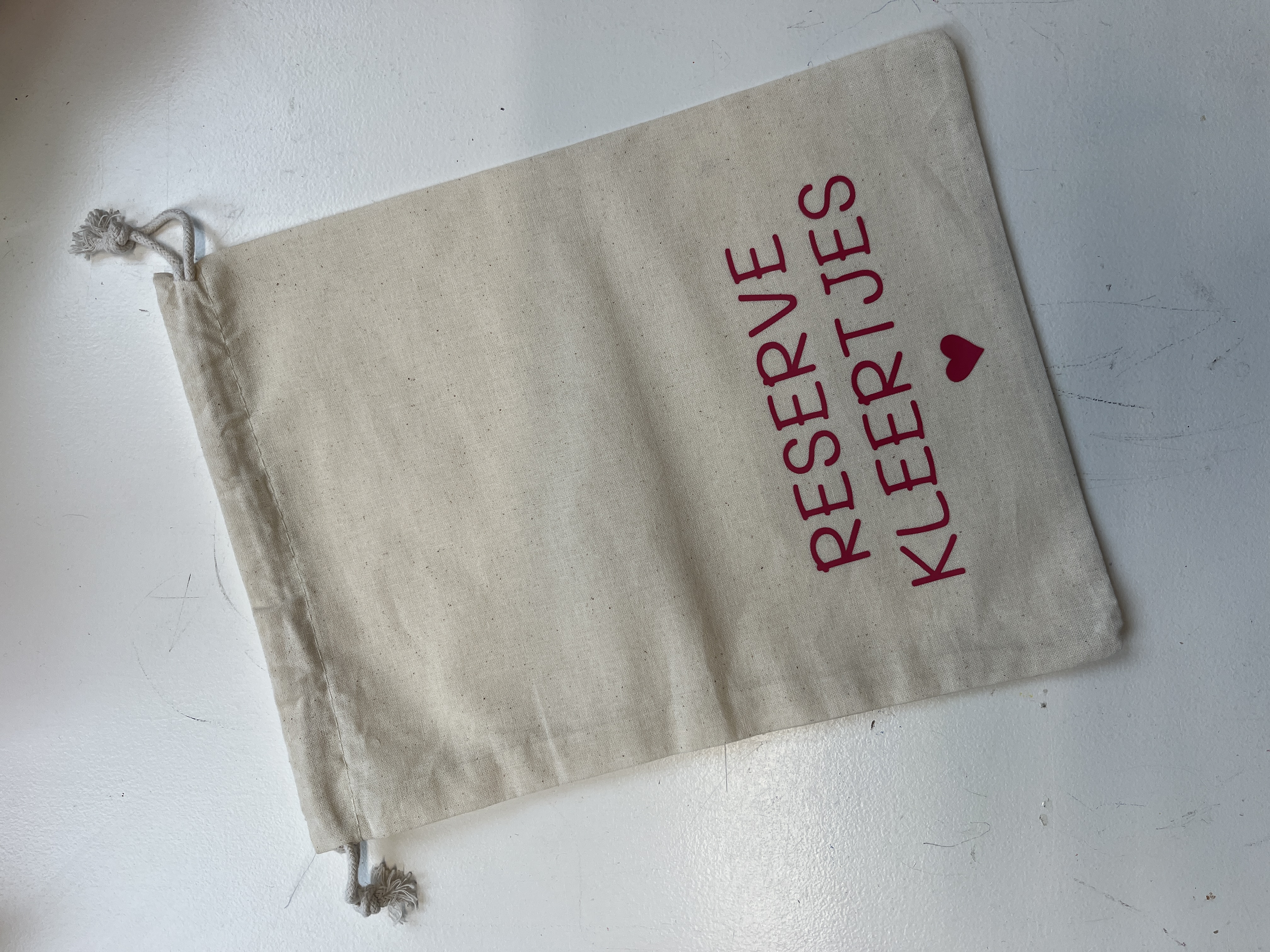 Zakje reserve kleertjes roze