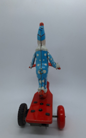 Blikken clown op driewieler