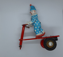 Blikken clown op driewieler