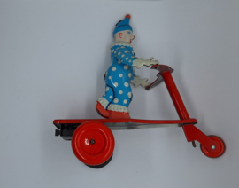 Blikken clown op driewieler