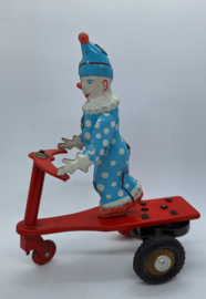 Blikken clown op driewieler