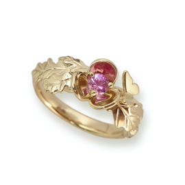 Golden engagement ring with flower, pink sapphire, oak leaf and a butterfly.